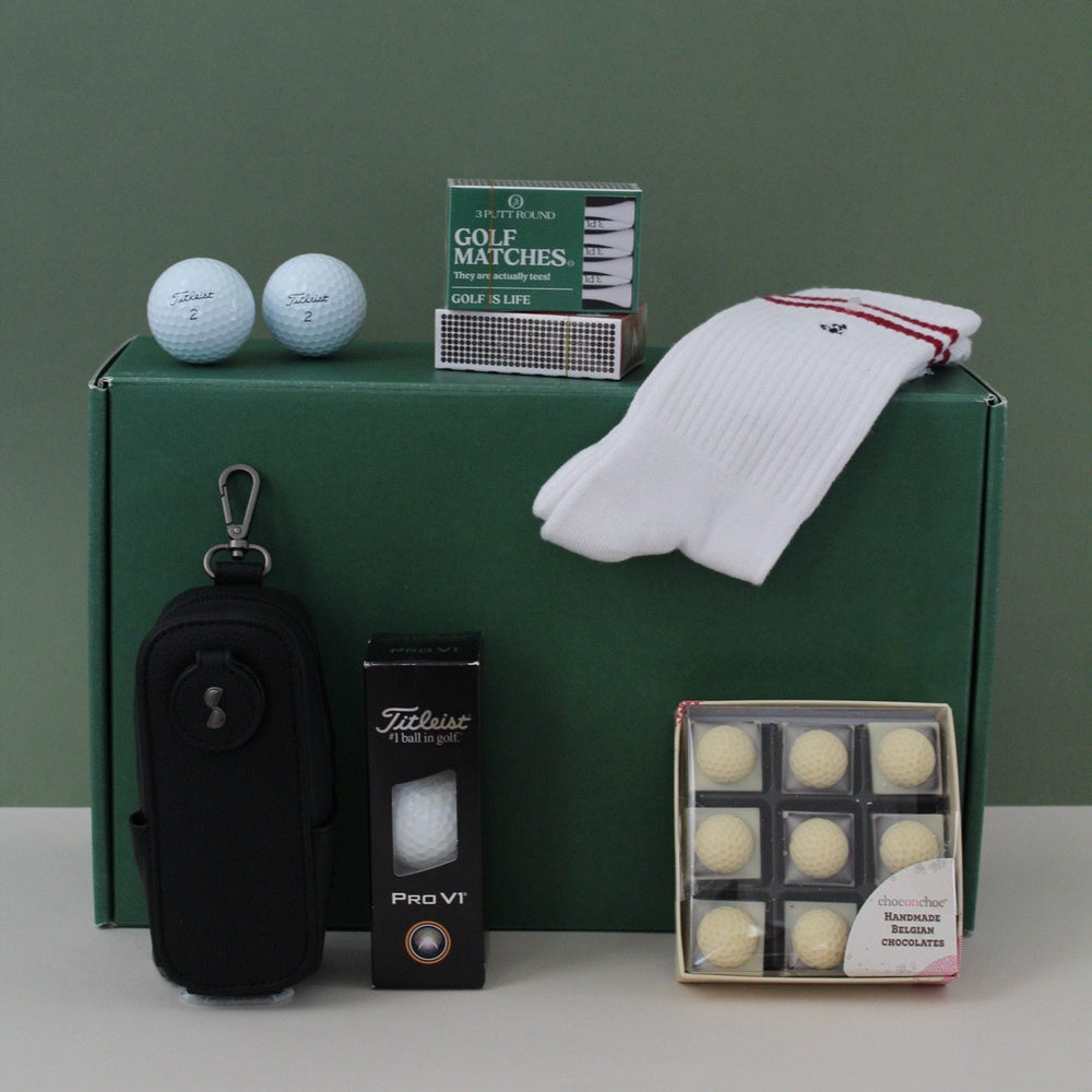 Golf gift box with athlete socks, golf balls, golf tees, golf caddy accessory and golf ball chocolates