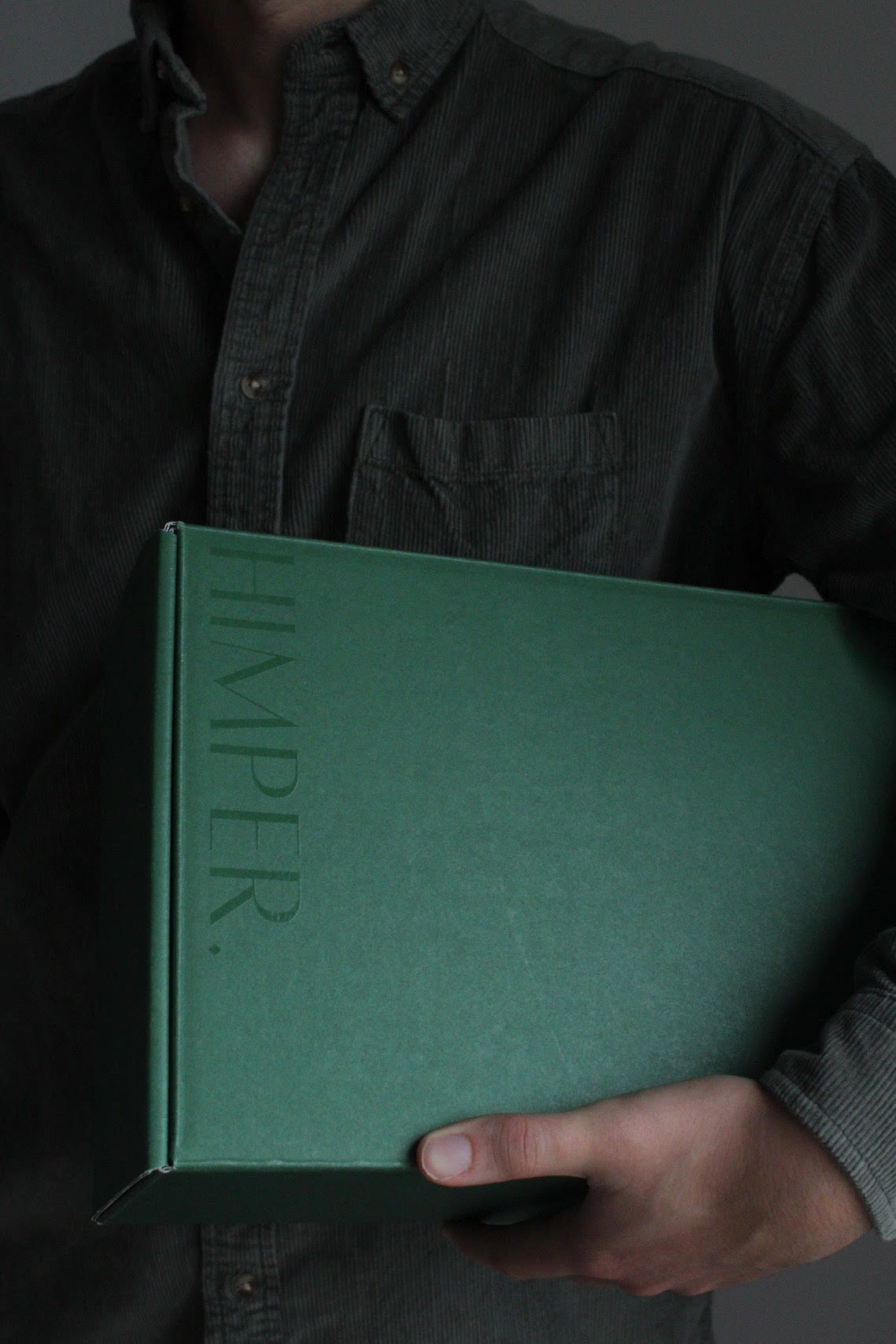 man holding green himper gift box