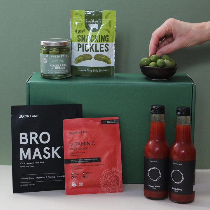 bloody mary gift box with hand grabbing on some olives