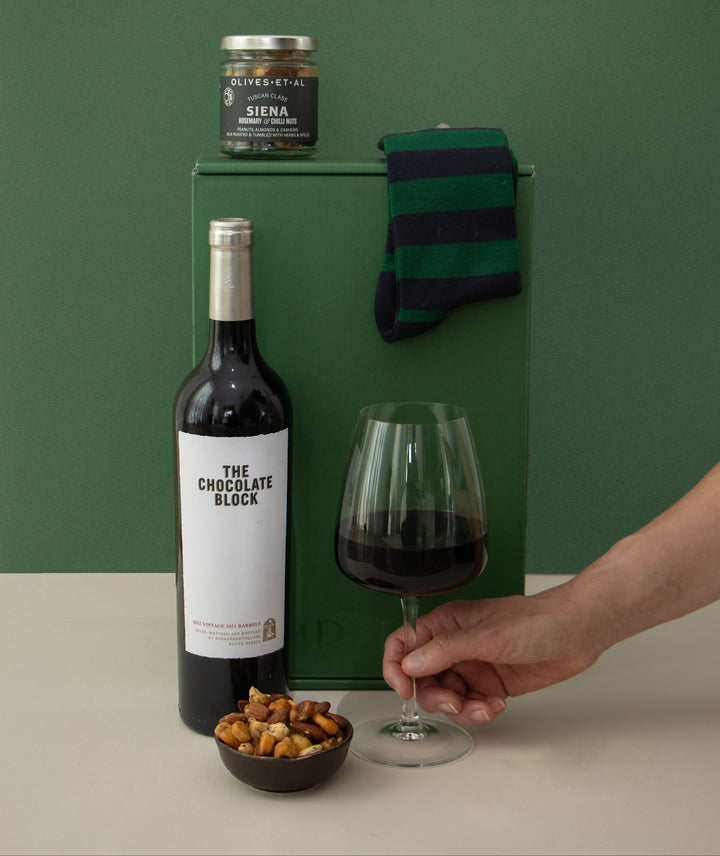 hand holding wine with socks and nuts
